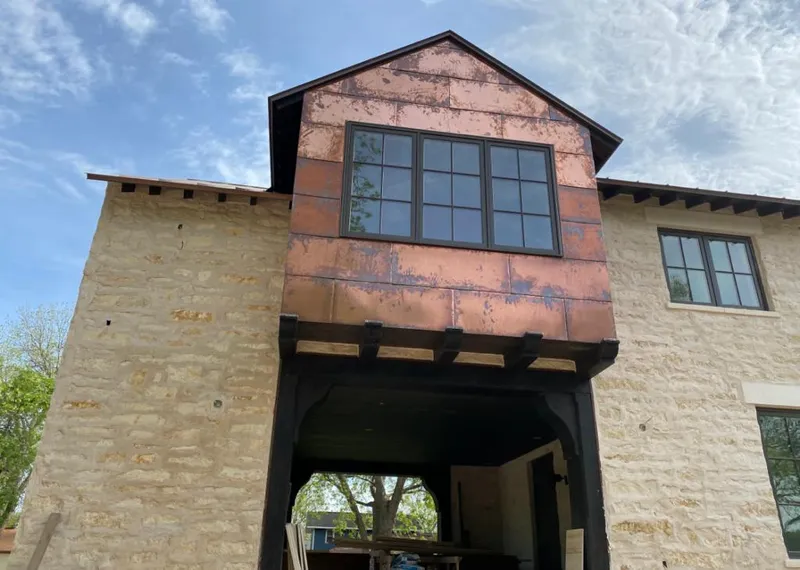 Copper metal panel facade on a stone building for Skylight Installation in Bowie